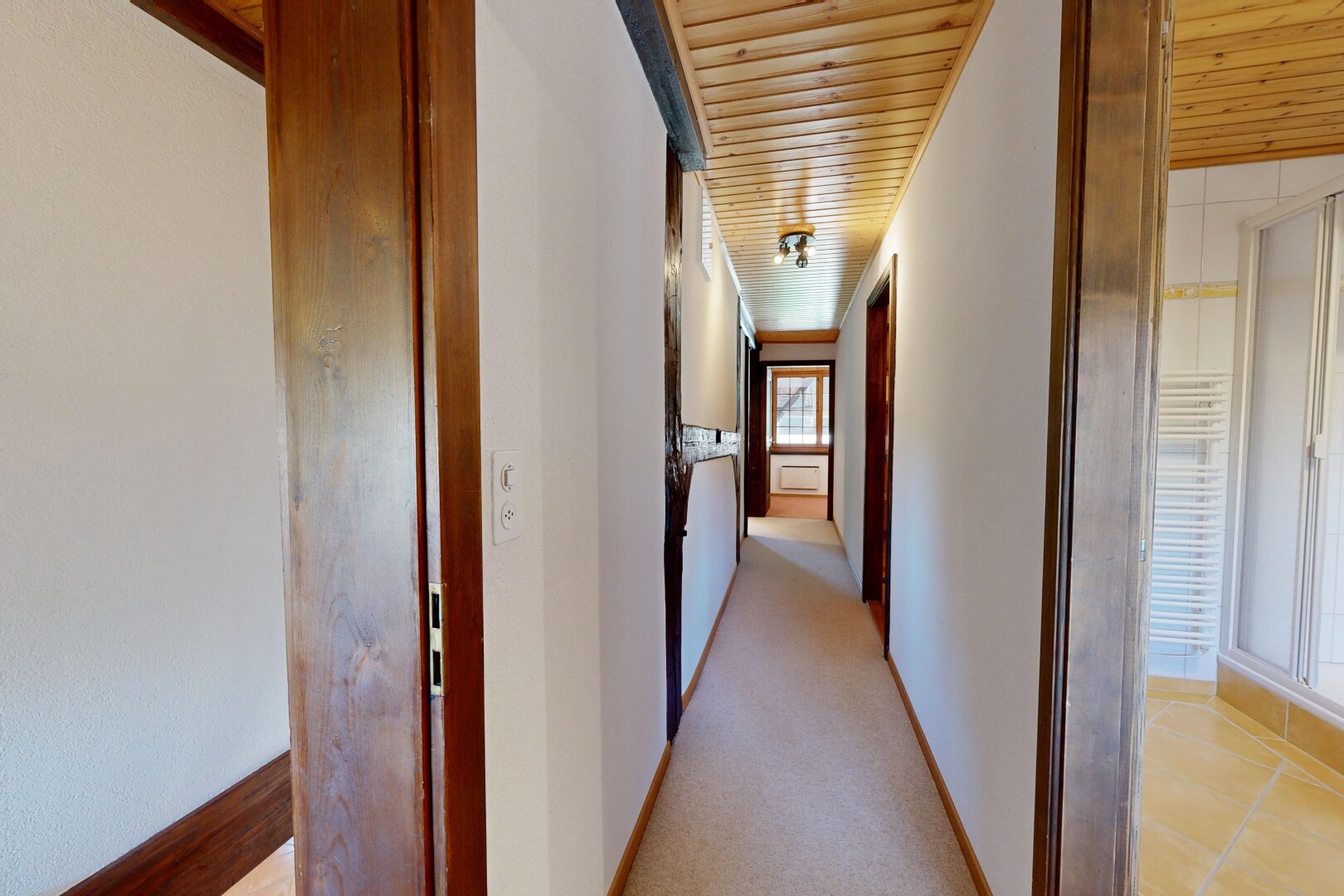 halle / korridor mit wood ceiling, holzdecke, inside property, carpet, und teppich