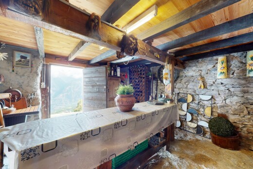 salle à manger avec inside property, beamed ceiling, plafond à poutres, stone wall, et mur en pierre