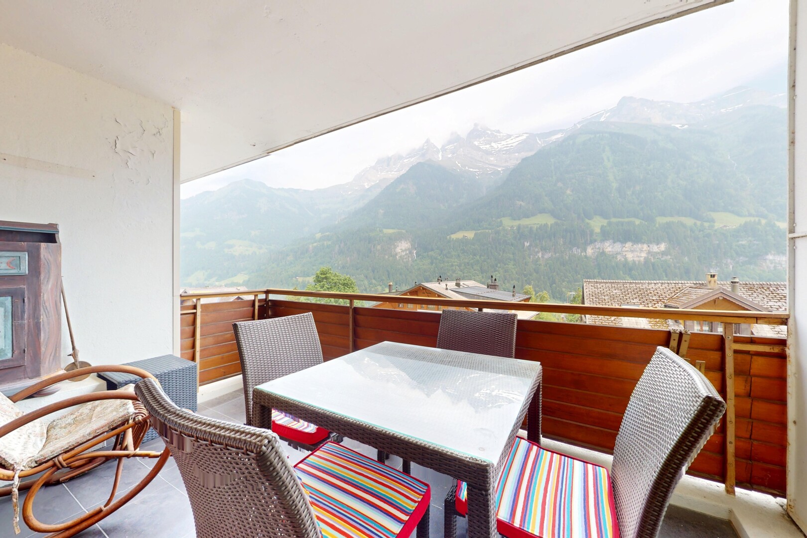 patio / terrace with a mountain view, outdoor dining area, and a balcony