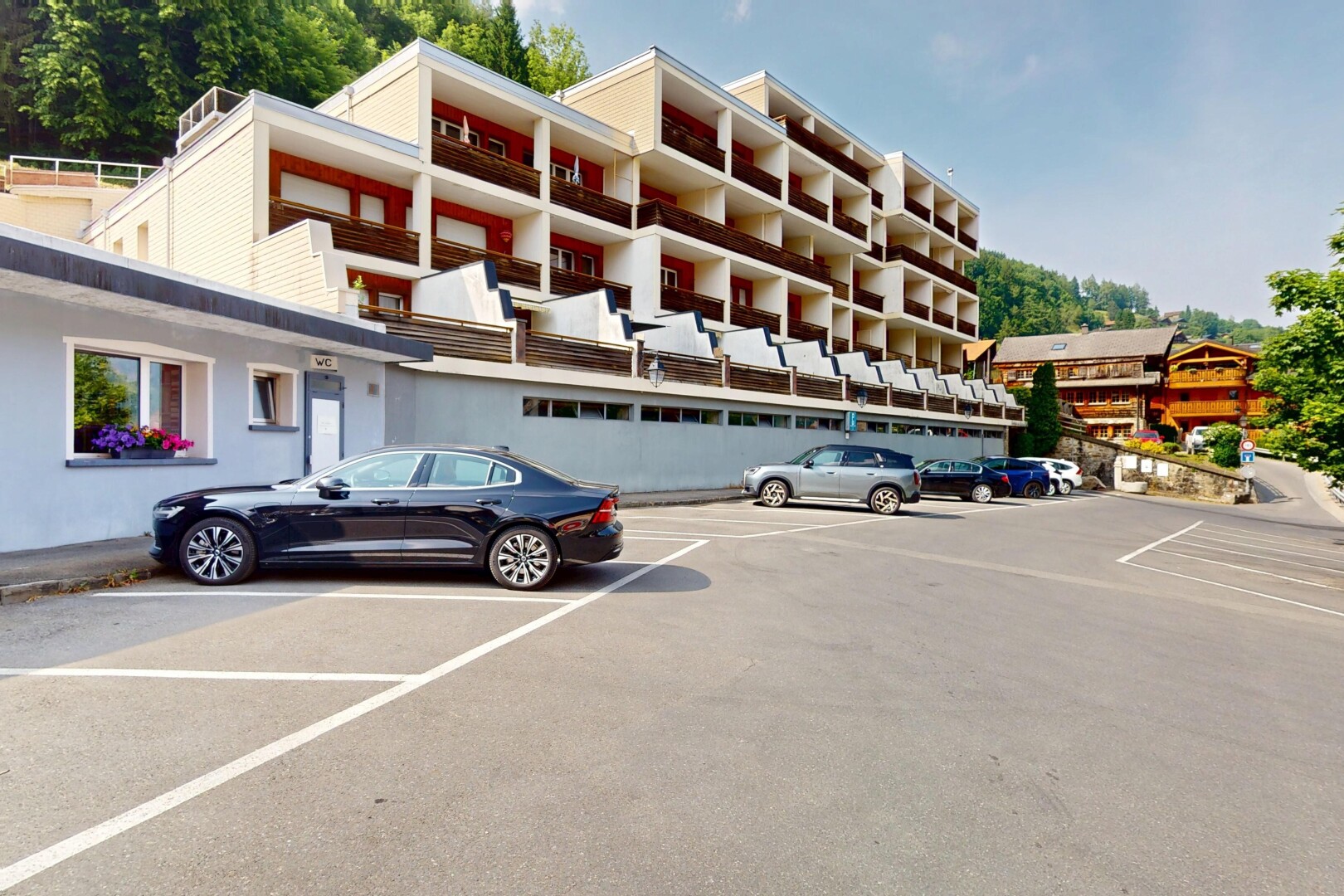 view of building exterior with uncovered parking