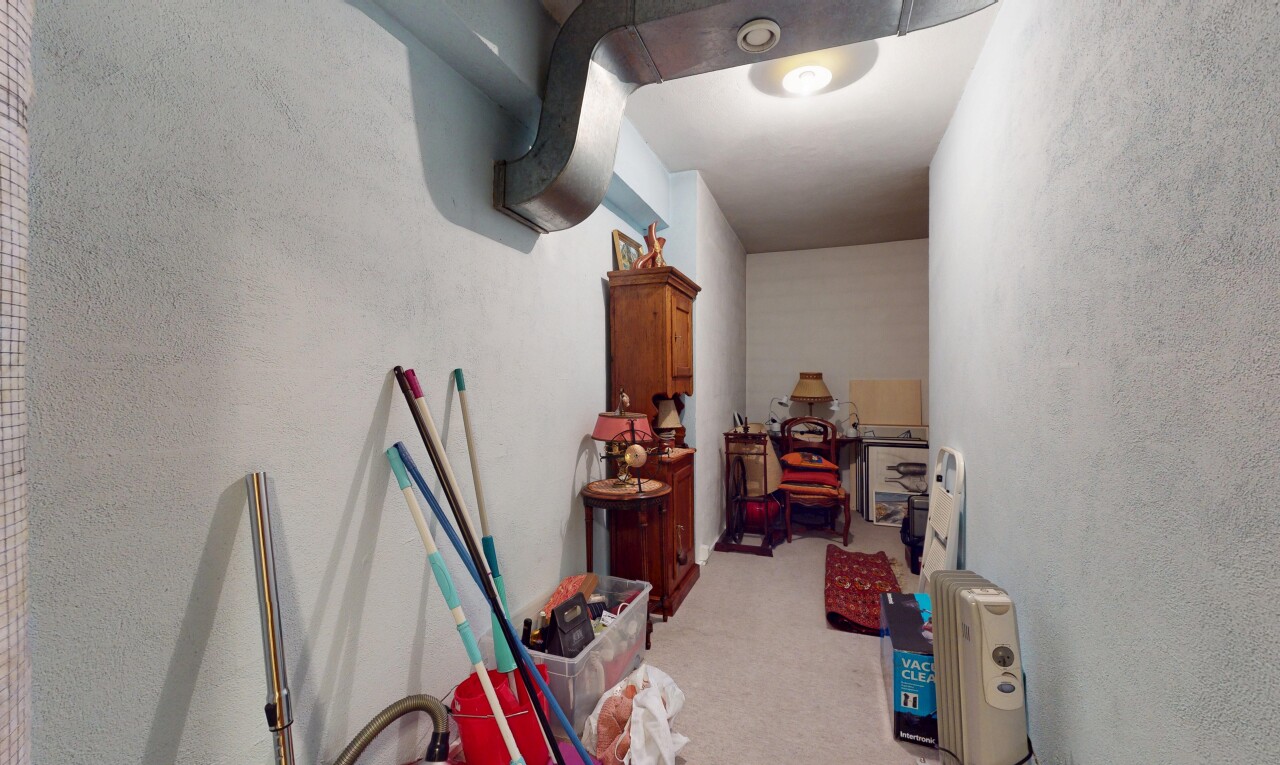 hallway featuring light colored carpet