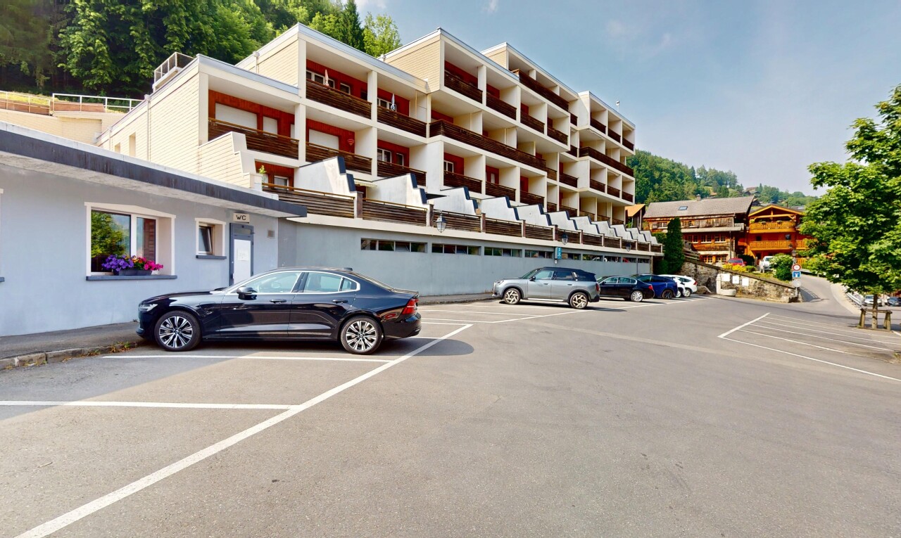 view of building exterior with uncovered parking