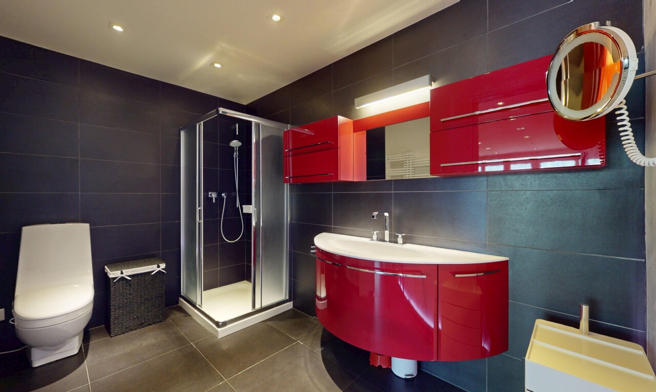 full bathroom with tile walls, a shower stall, tile patterned floors, and vanity