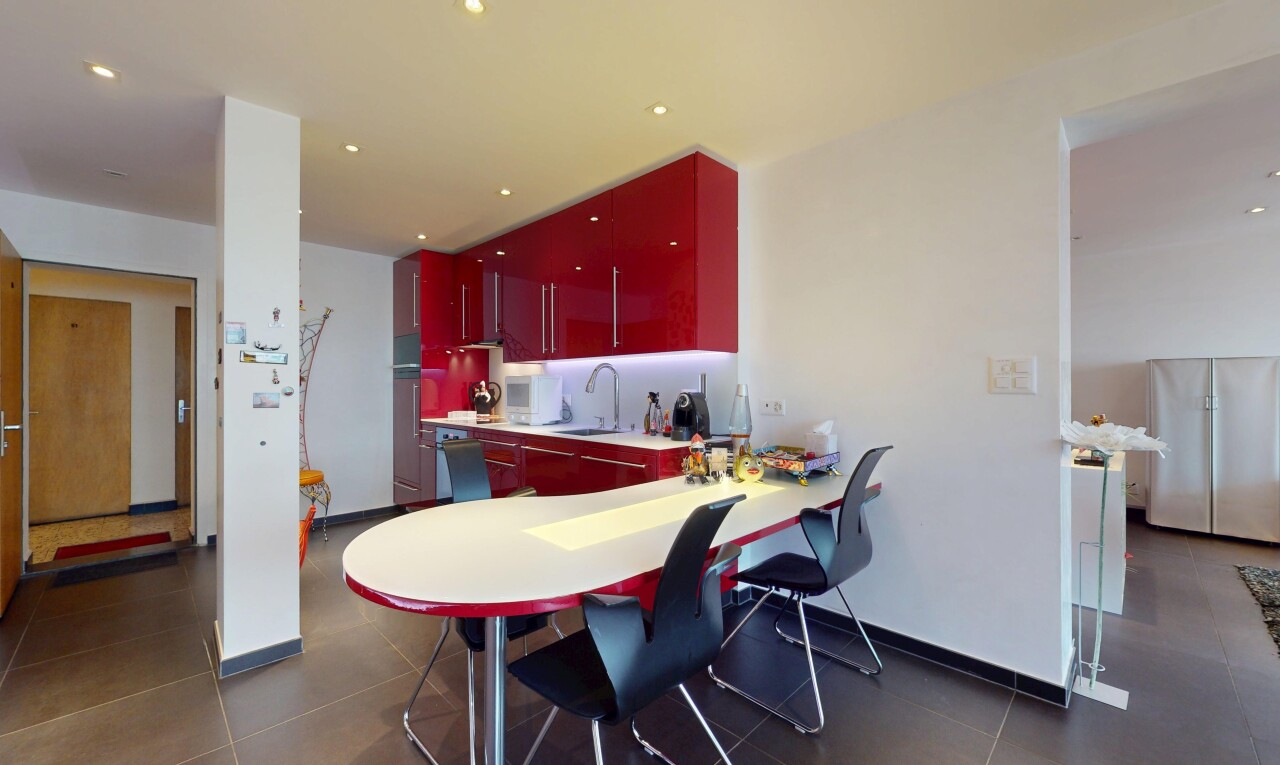 kitchen with red cabinets, freestanding refrigerator, recessed lighting, and light countertops