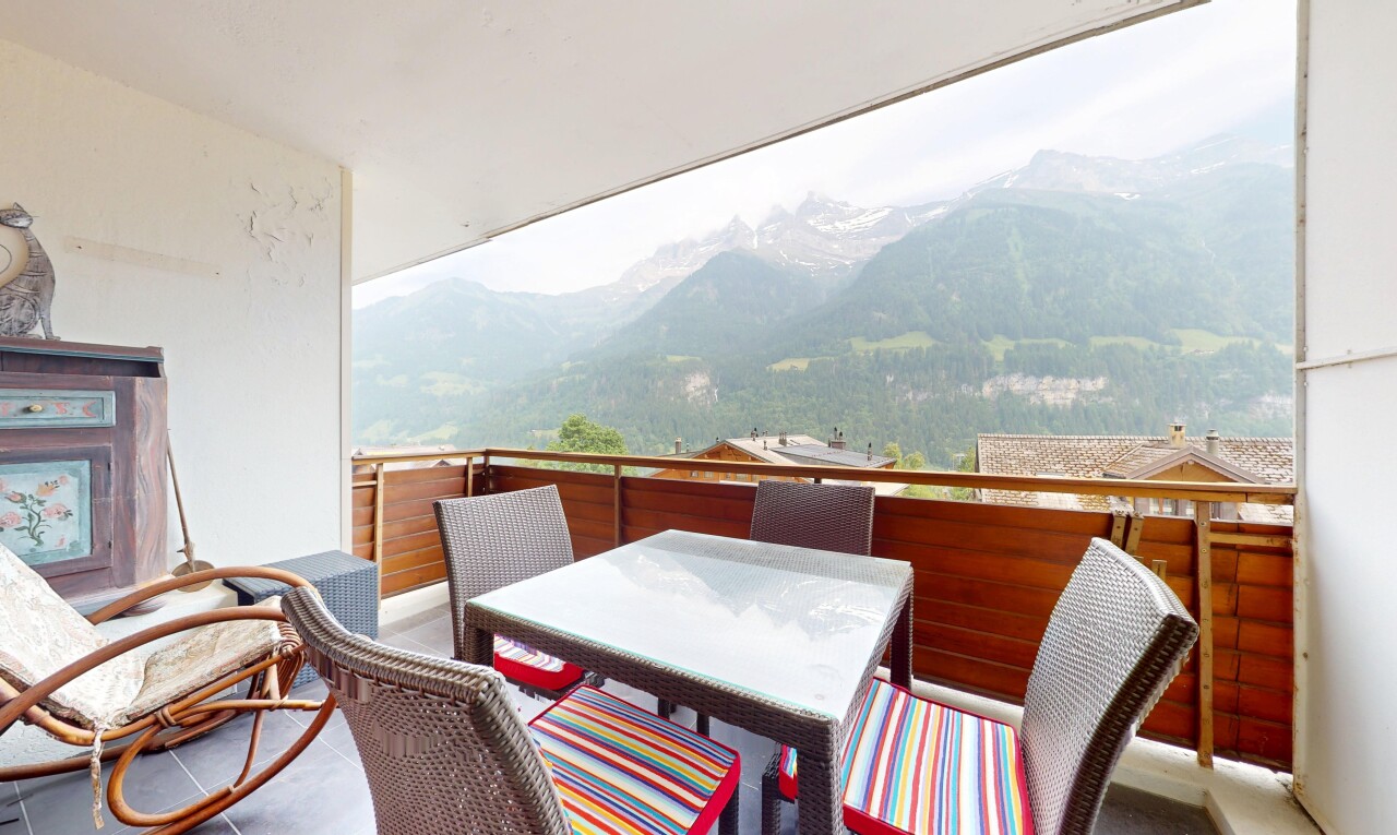 patio / terrace with a mountain view, outdoor dining area, and a balcony