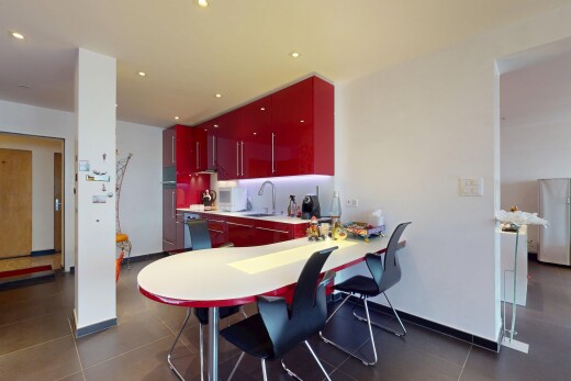 kitchen with red cabinets, freestanding refrigerator, recessed lighting, and light countertops