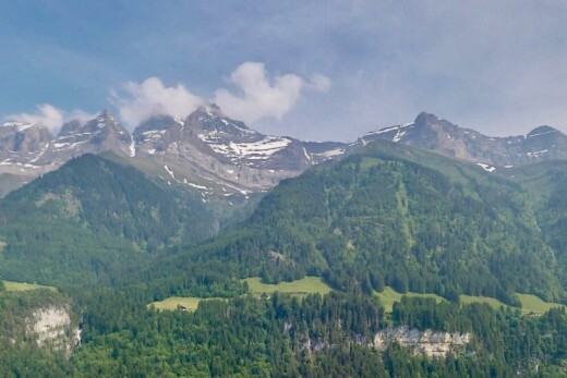 view of mountain backdrop featuring a forest