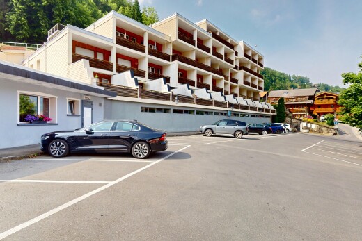 view of building exterior with uncovered parking