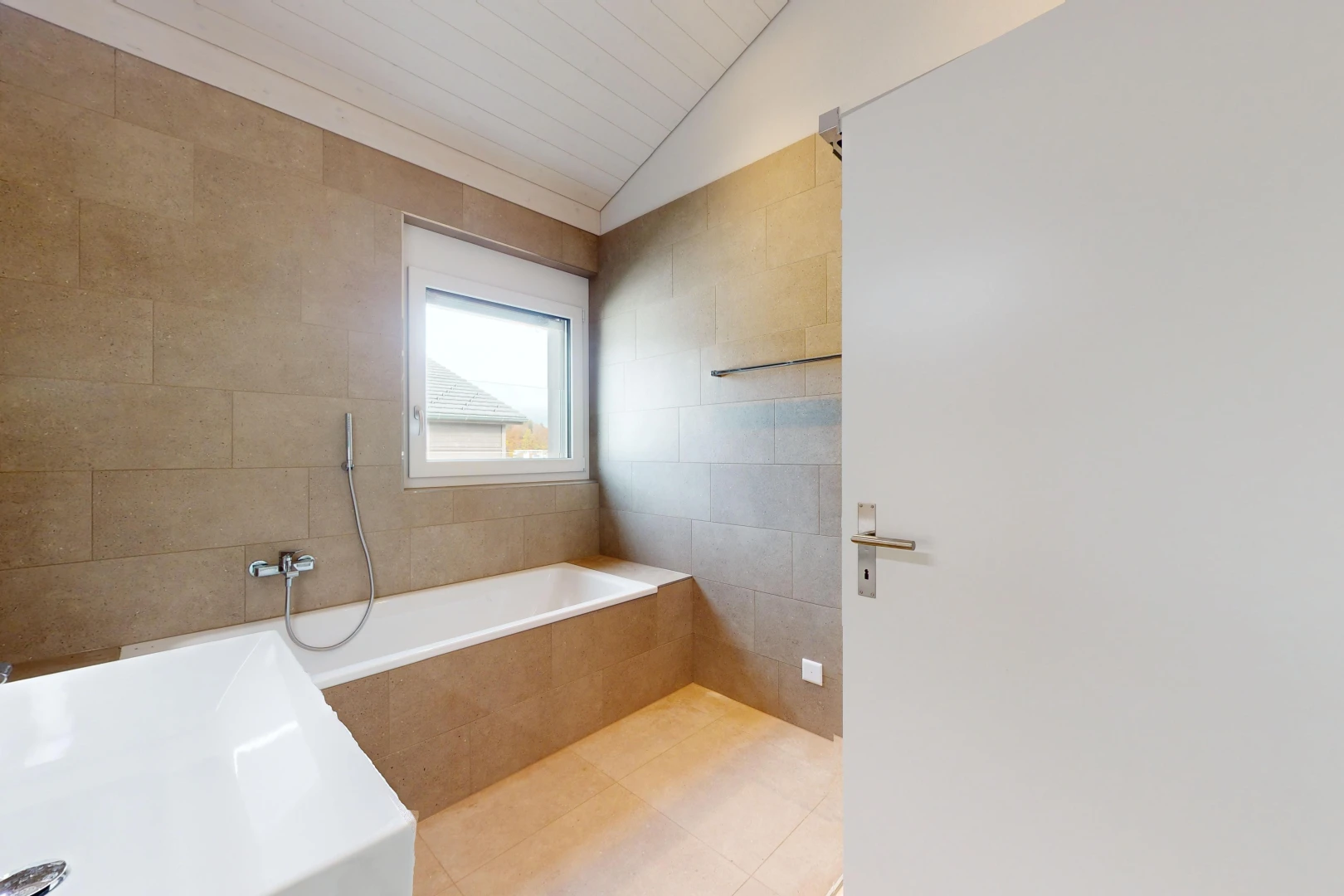 bathroom featuring separate shower and tub, tile walls, and lofted ceiling