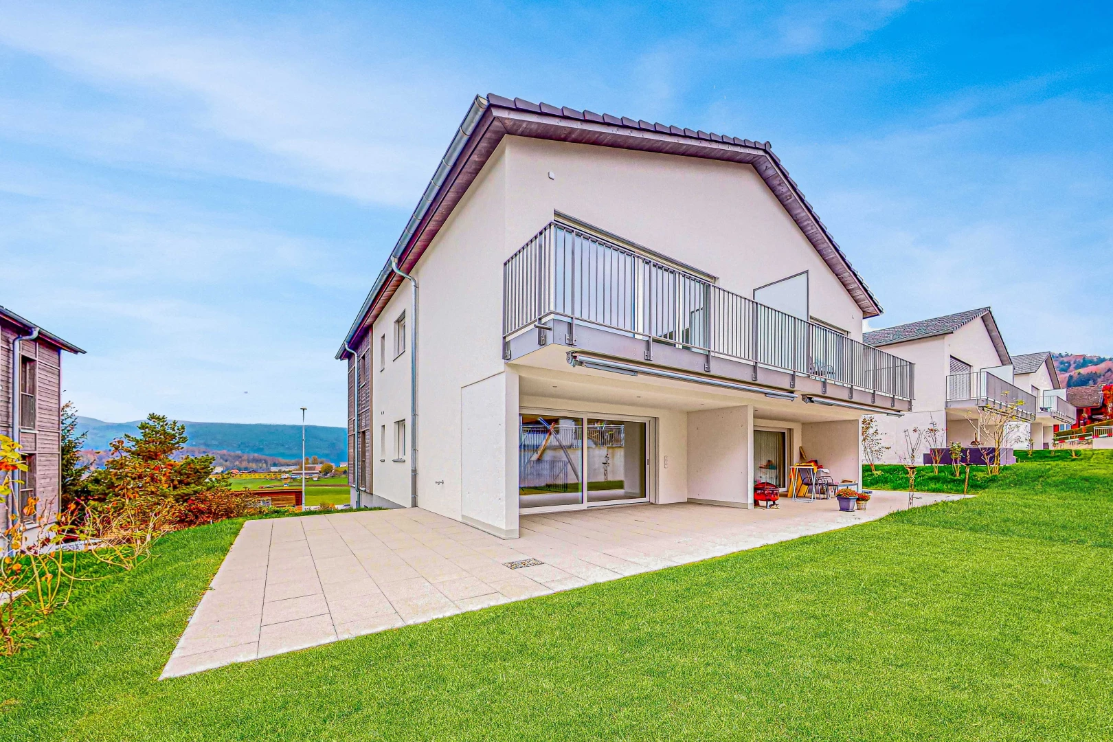 outdoor house featuring a patio area, a balcony, and a yard