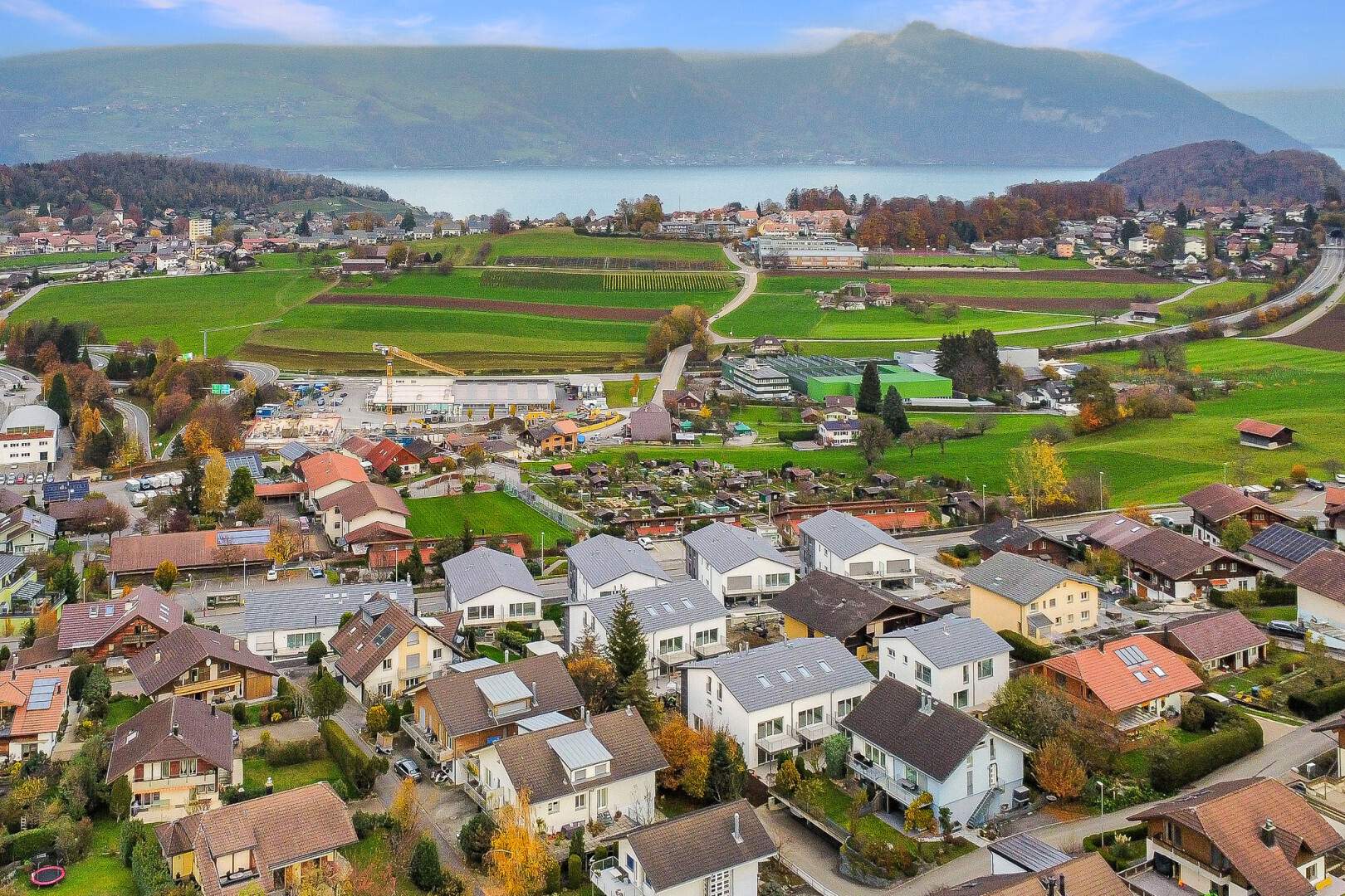 view of mountain background with nearby suburban area and a large body of water