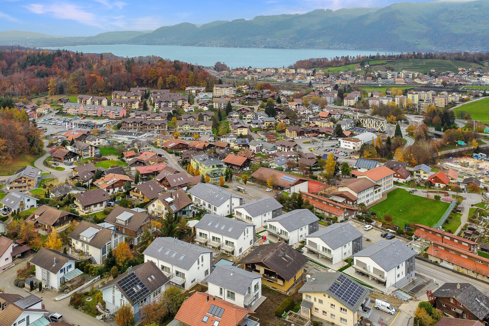 view of mountain background with nearby suburban area and a nearby body of water