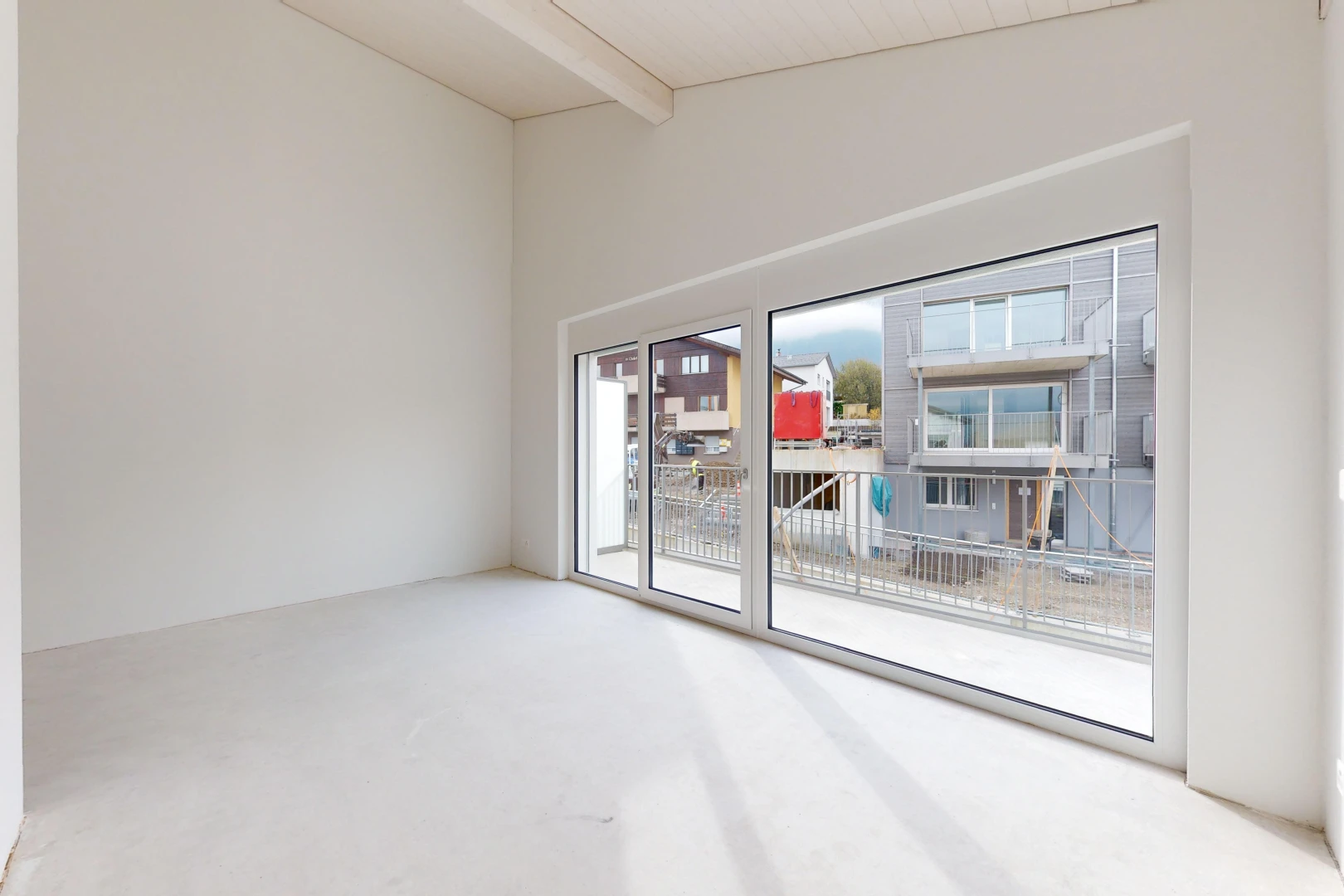 unfurnished room with carpet flooring and vaulted ceiling with beams