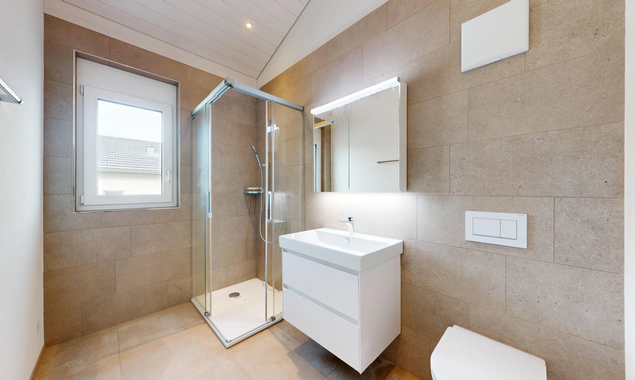 bathroom with vanity, lofted ceiling, tile patterned floors, walk in shower, and tile walls