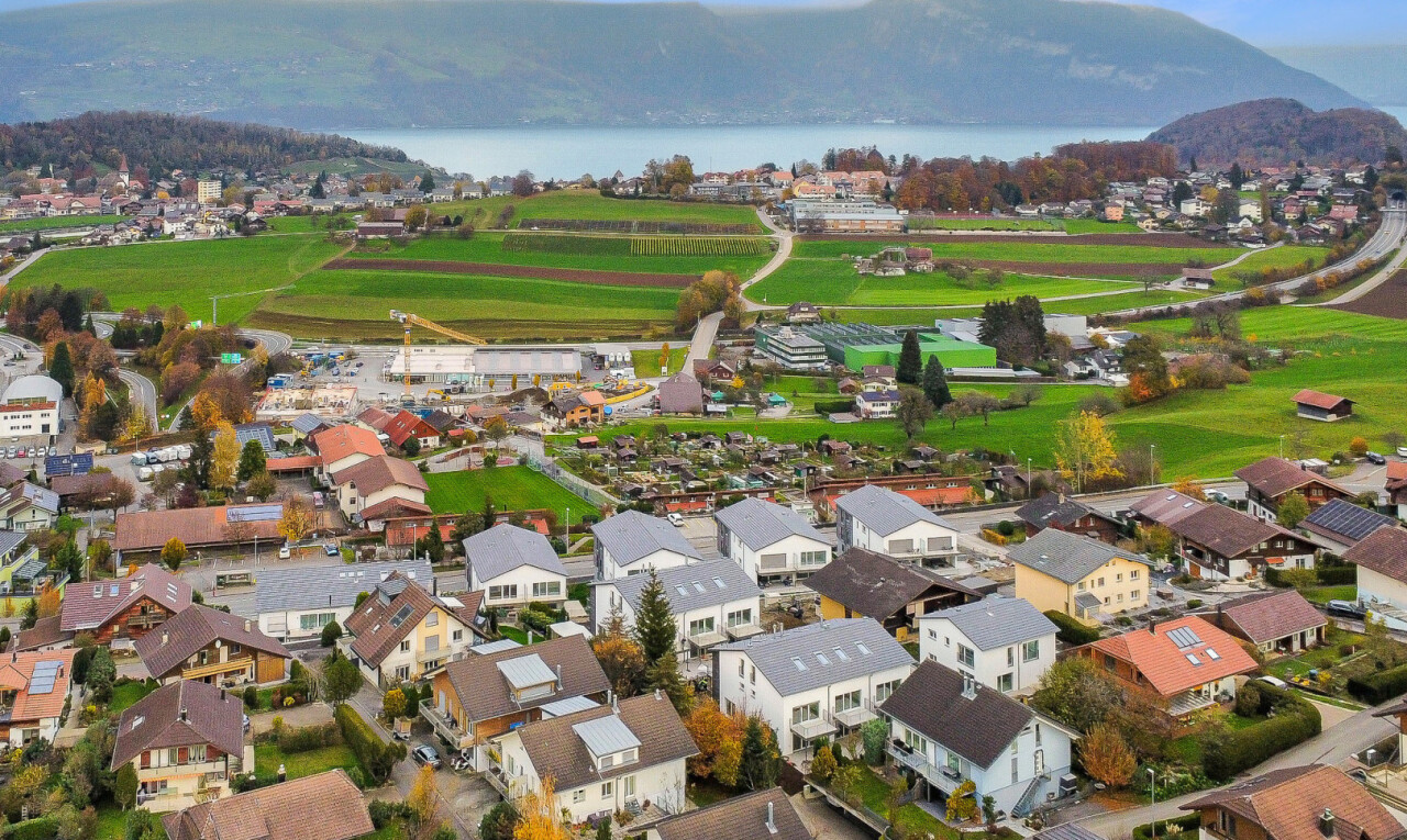 view of mountain background with nearby suburban area and a large body of water