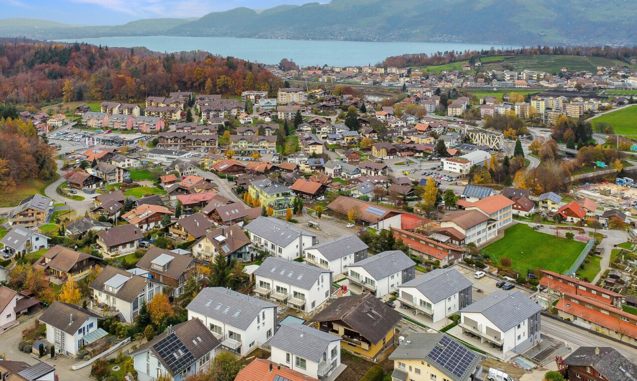 view of mountain background with nearby suburban area and a nearby body of water
