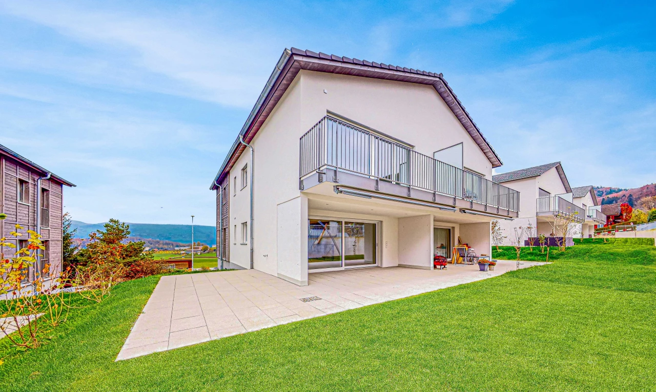 outdoor house featuring a patio area, a balcony, and a yard