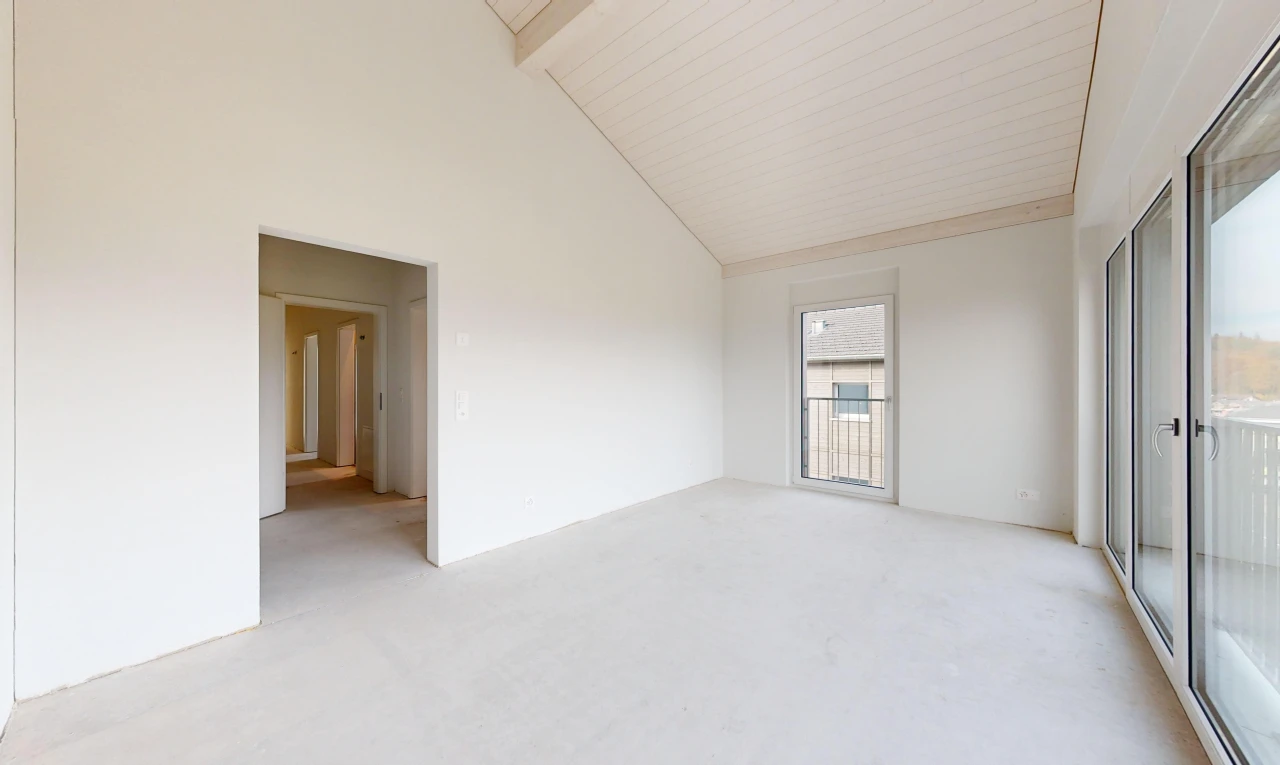 empty room with beam ceiling, light carpet, and high vaulted ceiling