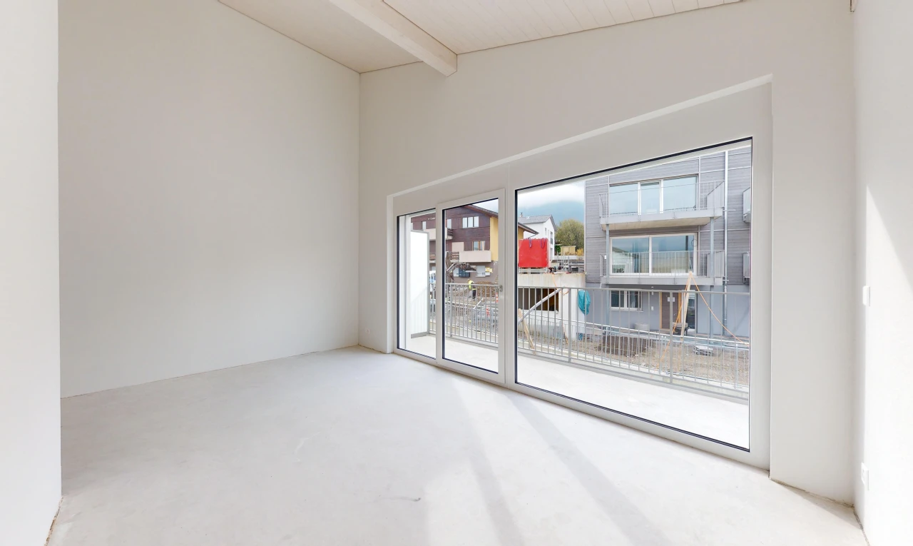 unfurnished room with carpet flooring and vaulted ceiling with beams