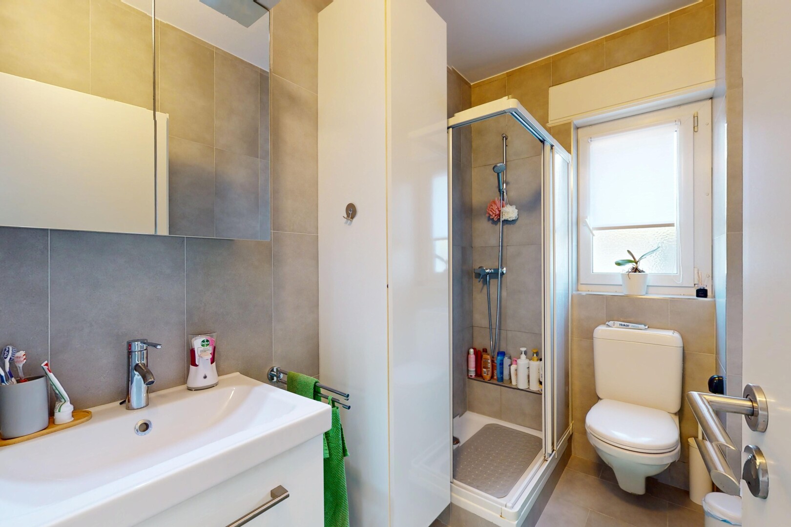 bathroom with vanity, a stall shower, toilet, and tile walls