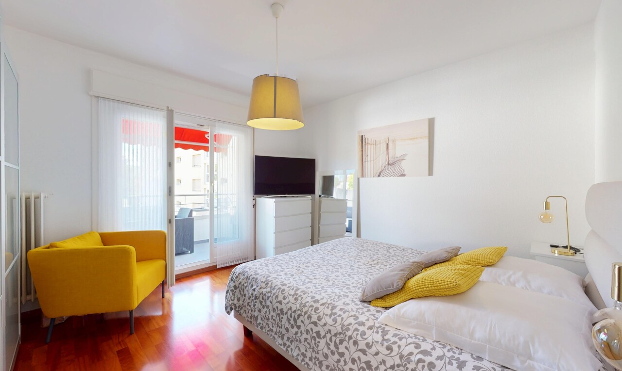 room / bedroom featuring access to exterior and wood finished floors