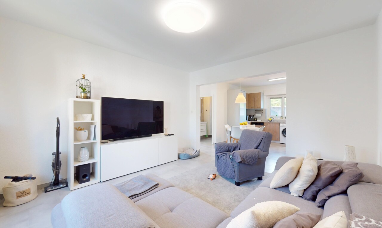 living room featuring light carpet and washer / clothes dryer