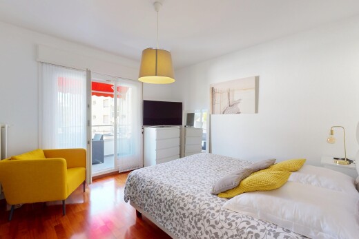 room / bedroom featuring access to exterior and wood finished floors