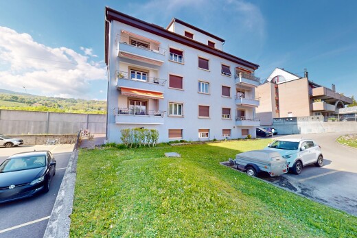 view of building exterior with uncovered parking