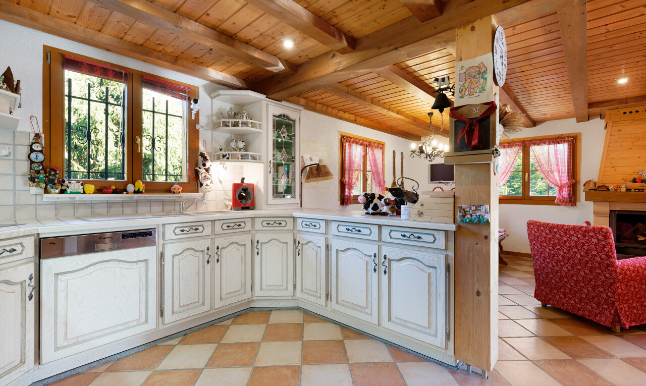 cuisine avec armoires en arc, étagères ouvertes, plans de travail, armoires élevées, et lumière naturelle