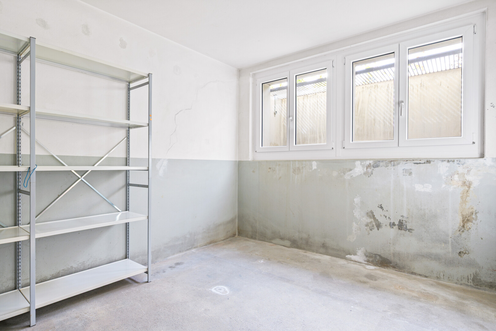 pièce vide avec inside property, natural light, lumière naturelle, concrete floor, et sol en béton