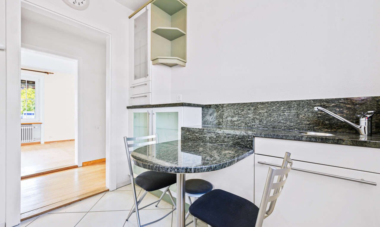 küche mit stein arbeitsplatten, weiße schränke, drywall, gipskartonwand, und offene regale