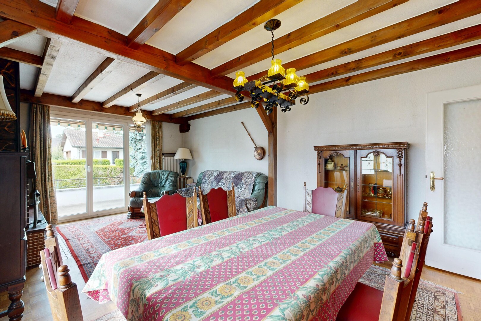 dining space with beam ceiling, hanging light fixtures, and light wood-style floors