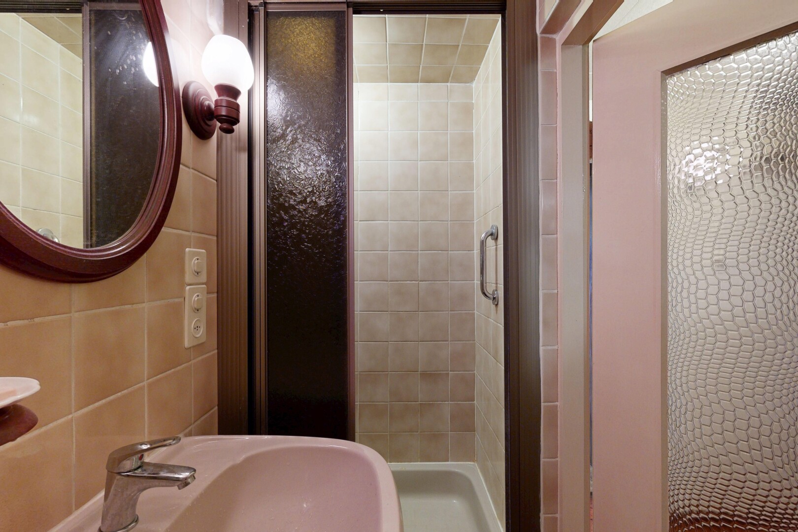 full bathroom featuring a stall shower and tile walls
