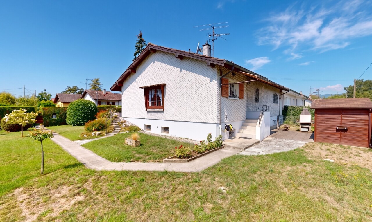 view of property featuring a yard and a storage unit