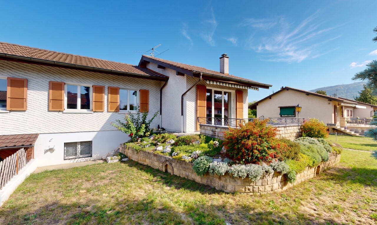 view of home featuring a yard and a chimney