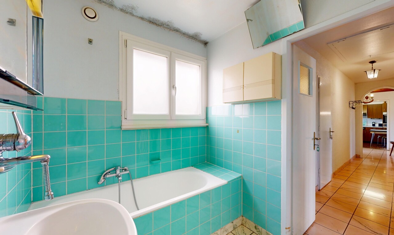 full bathroom featuring a bath, tile walls, and light tile patterned floors