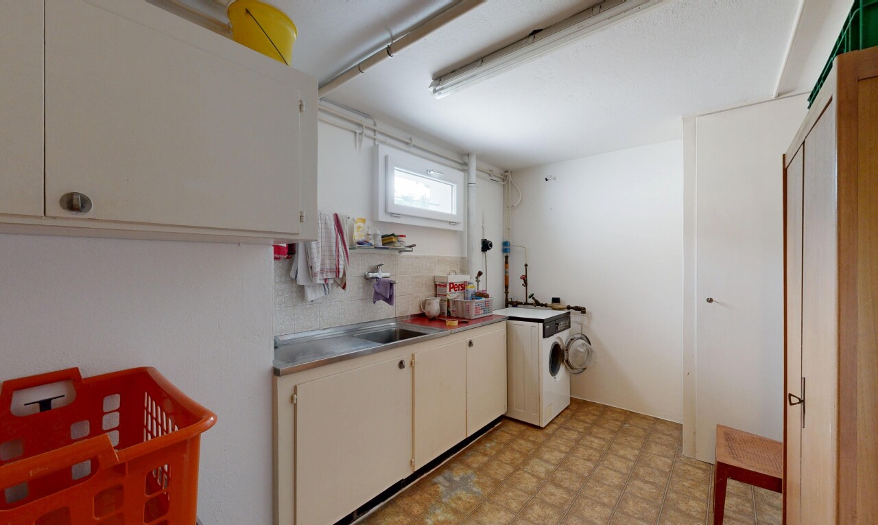 kitchen featuring light flooring, washer / clothes dryer, and cream cabinets