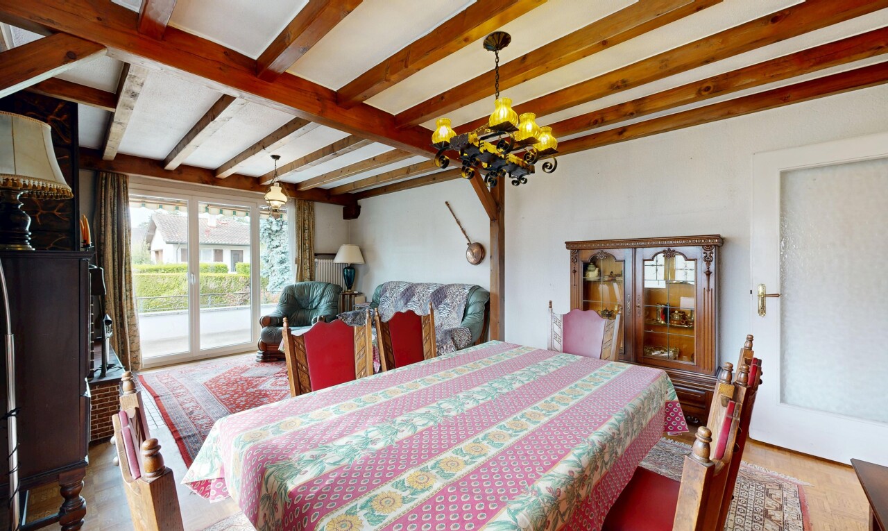 dining space with beam ceiling, hanging light fixtures, and light wood-style floors