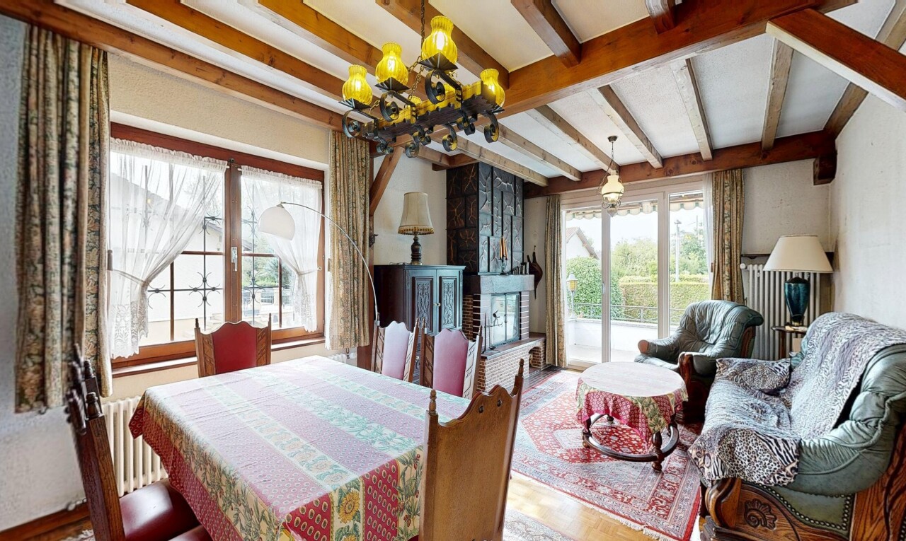 living / dining room featuring beam ceiling, radiator, hanging light fixtures, and wood finished floors
