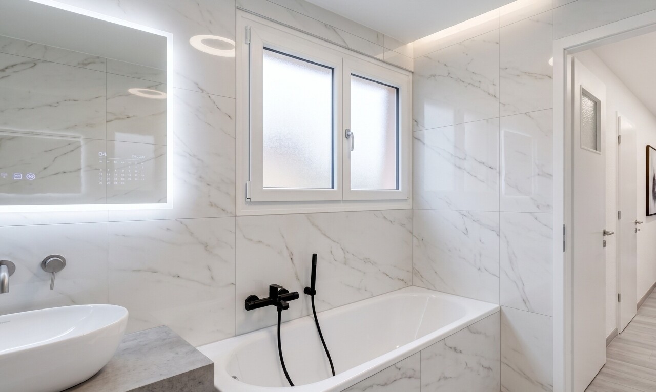 full bathroom featuring a bath, tile walls, and light tile patterned floors