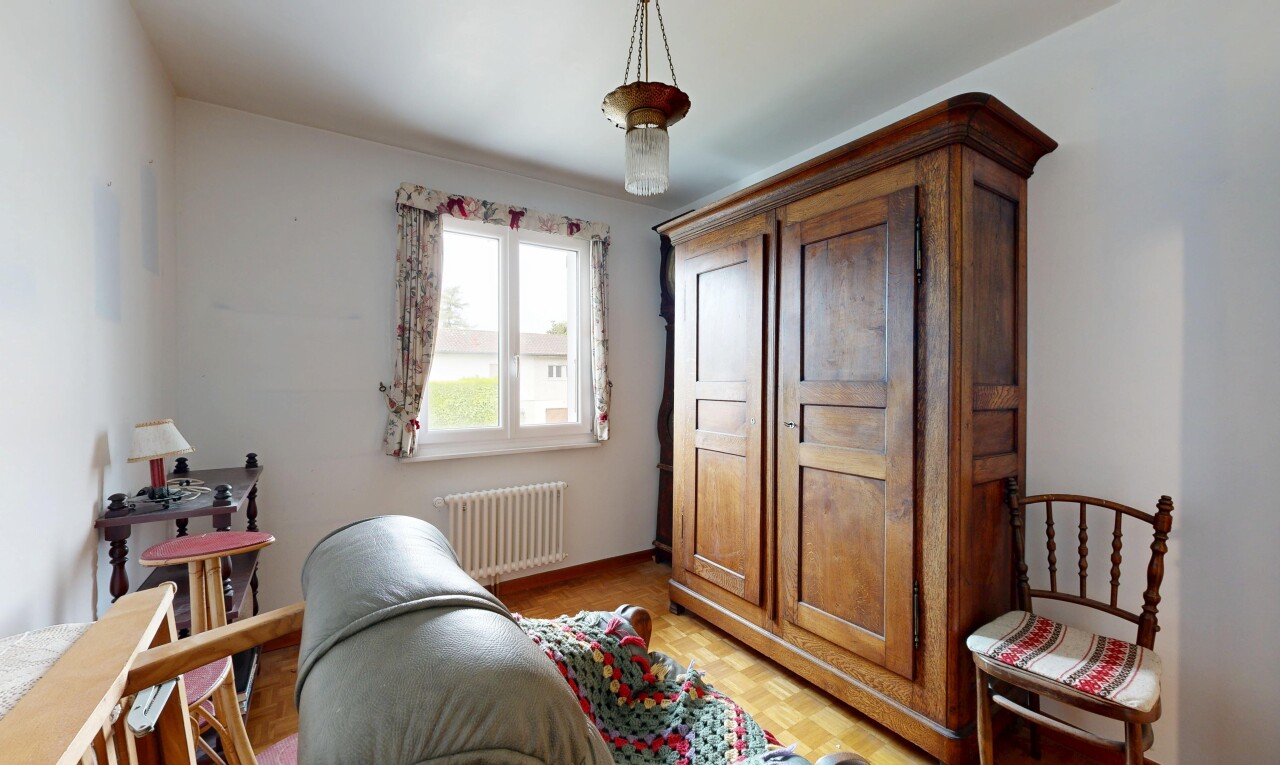 room / bedroom with radiator heating unit, parquet floors, and hanging light fixtures