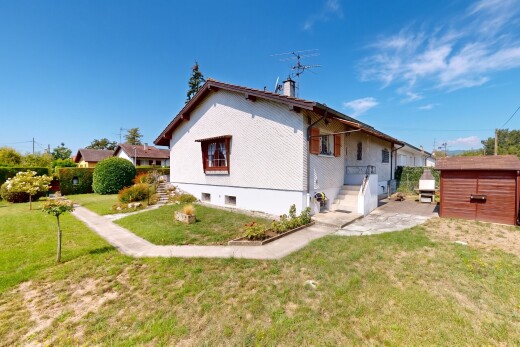 view of property featuring a yard and a storage unit