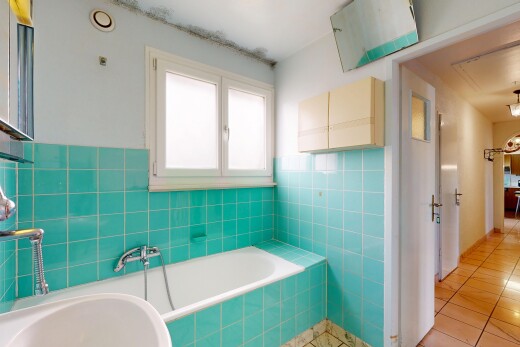 full bathroom featuring a bath, tile walls, and light tile patterned floors