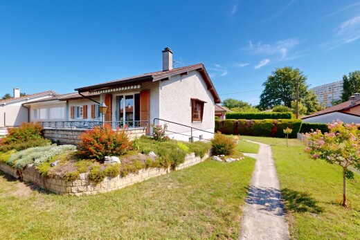 view of home with a chimney and a yard