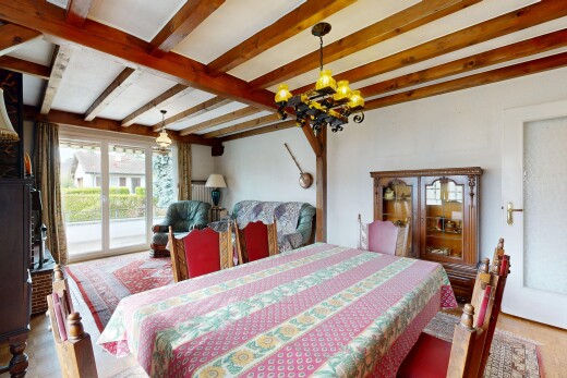 dining space with beam ceiling, hanging light fixtures, and light wood-style floors