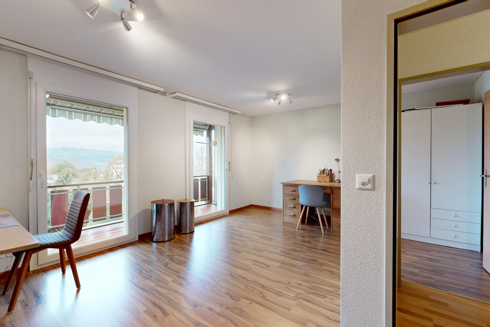 unfurnished room featuring a desk and light wood finished floors