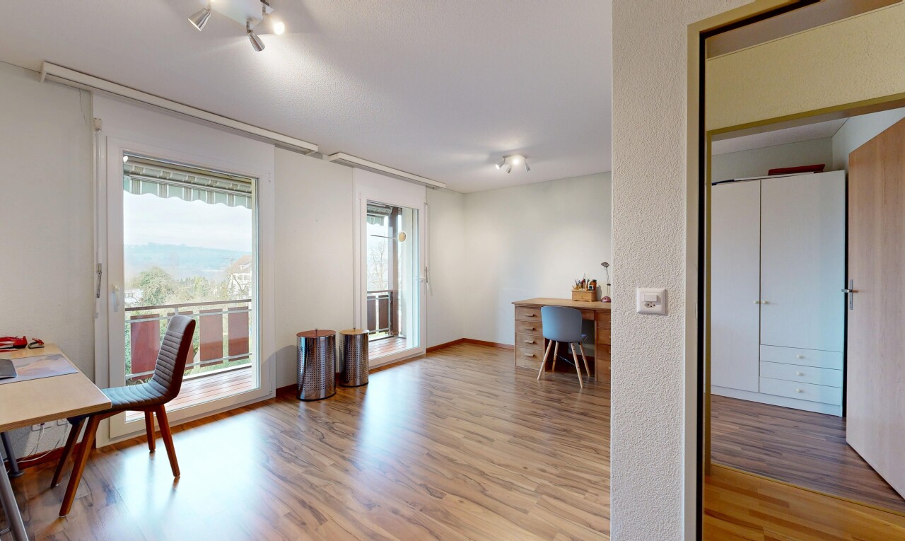 unfurnished room featuring a desk and light wood finished floors