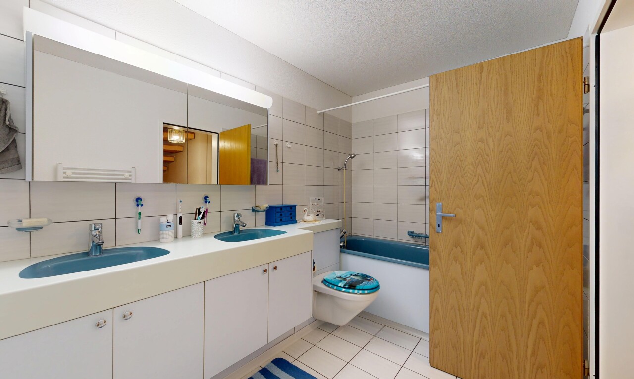 bathroom with double vanity,  shower combination, light tile patterned floors, and tasteful backsplash