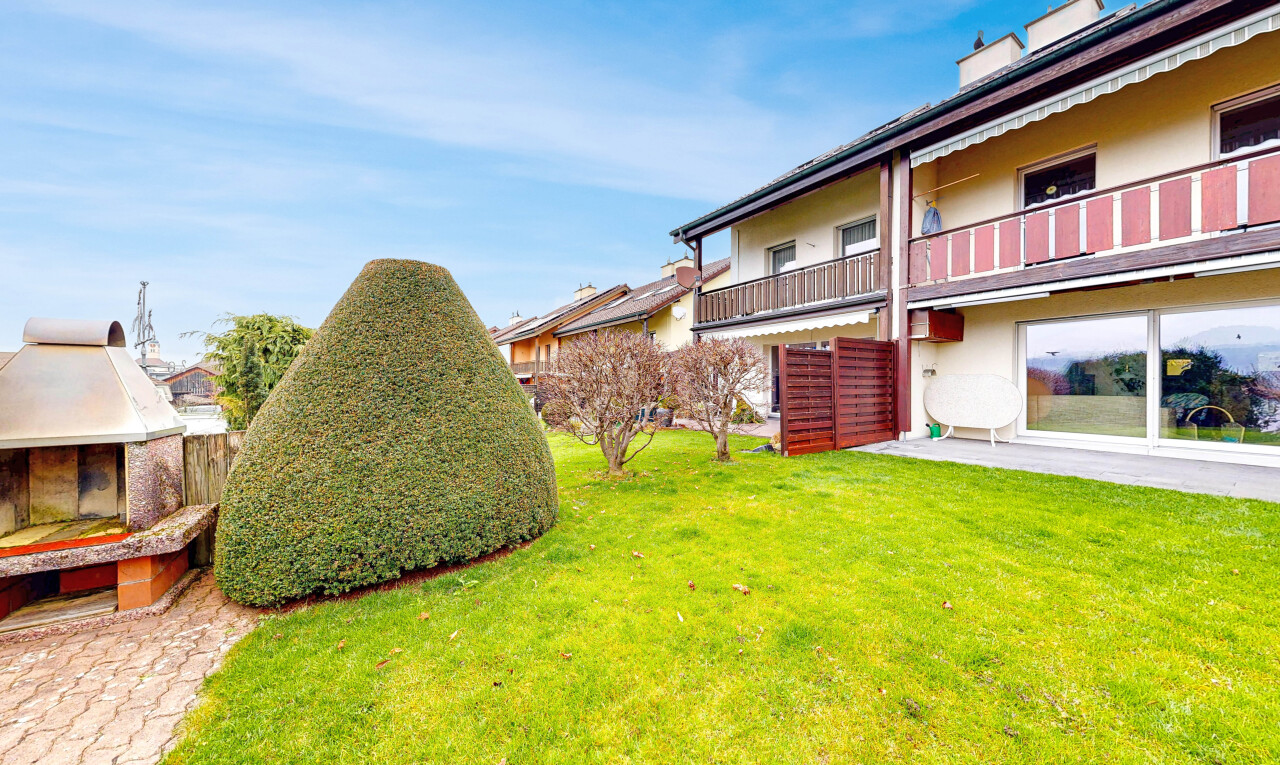 garden featuring a lawn and a balcony