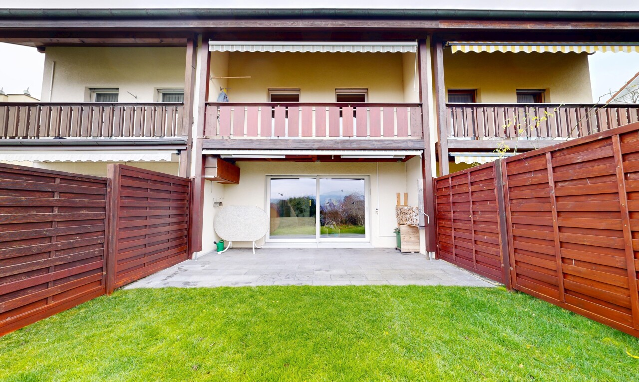view of property with a fenced backyard, stucco siding, a balcony, and a patio area